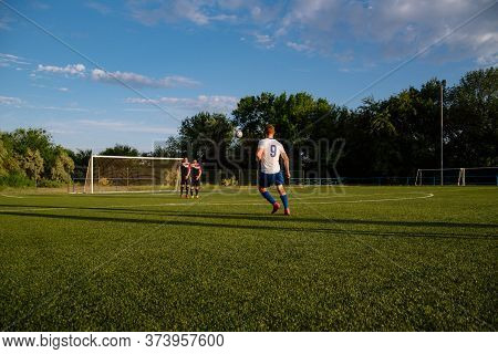 Soccer Player Kicks The Ball.soccer Player Takes The Free-kick.