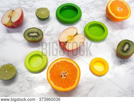Variety Of Cut Fruits And Colorful Reusable Silicone Food Wraps For Reducing Food Waste In A Zero Wa