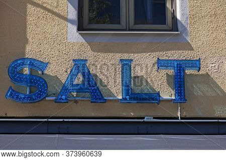 A Blue Diode Sign Under A Window Where It Says Salt