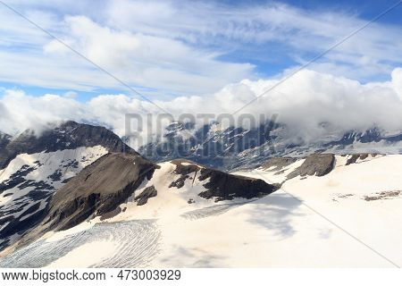 Mountain Snow And Glacier Panorama With Clouds In Glockner Group, Austria