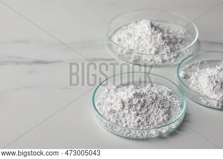 Petri Dishes With Calcium Carbonate Powder On White Marble Table. Space For Text