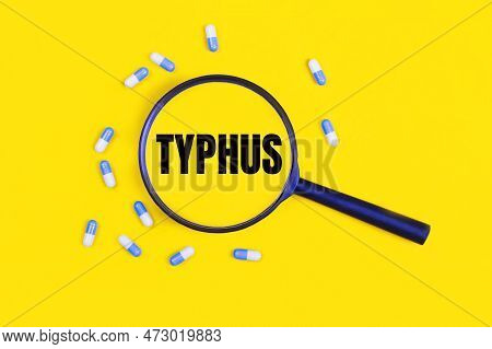 Pharmaceutical Tablets And Capsules Near A Magnifying Glass With The Text Typhus On A Yellow Backgro