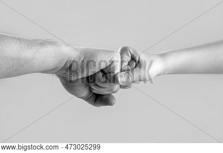 Little And Big Fists Of Father And Son. Mother And Kid Daughter Are Fist Bumping. Black And White