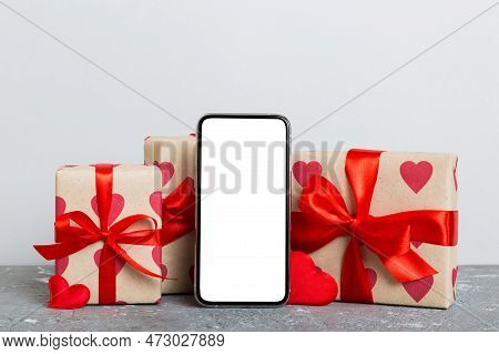 Mobile Phone With Blank Screen On Colored Background With Hearts, Calendar And Gift Box, Valentine D