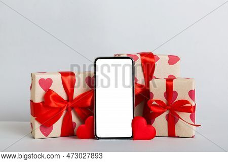 Mobile Phone With Blank Screen On Colored Background With Hearts, Calendar And Gift Box, Valentine D
