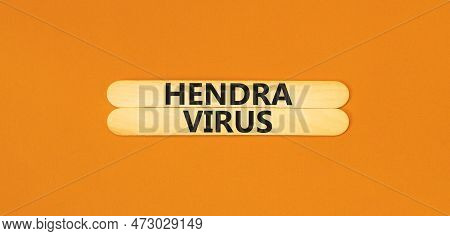 Hendra Virus Symbol. Concept Words Hendra Virus On Wooden Sticks. Beautiful Orange Table Orange Back