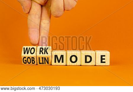 Work Or Goblin Mode Symbol. Concept Word Work Mode Goblin Mode On Wooden Cubes. Businessman Hand. Be