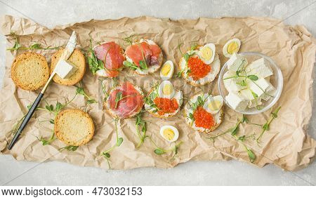 Canapes With Red Caviar And Canapes With Red Fish Are Decorated With Micro Greens, Quail Eggs Are On