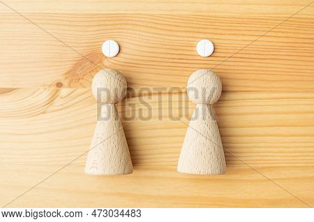 Family Health Concept. Pills And Wooden Men. A Single Dose Of Potassium Iodide. Protection Of The Fa
