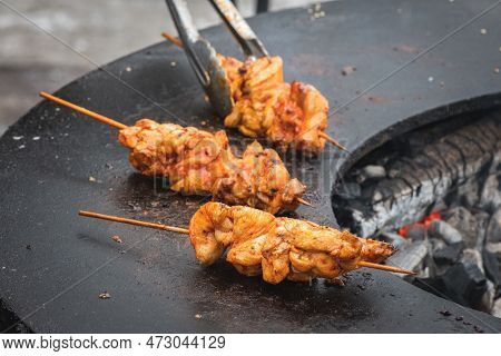 Preparing Chicken Meat Skewers, Grilled Or Roasted In A Barbecue On An Open Fire With Flames, Shashl