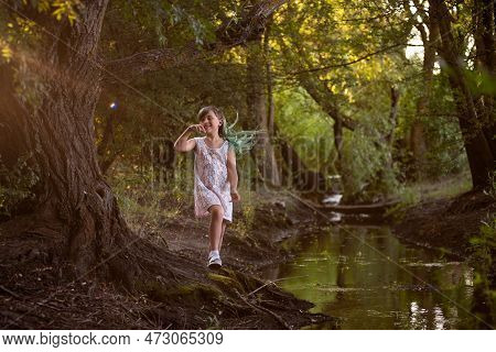 Teenage Girl Fooling Around Near Small River, Stream. Diversity Child Generation Z With Green Hair