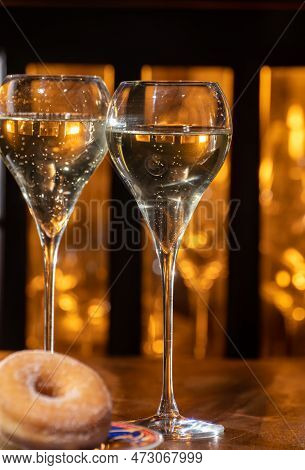 Glass Of Brut Champagne Bubbles Wine In Tulip Glass And Glazed, Yeast-raised, American-style Ring Do