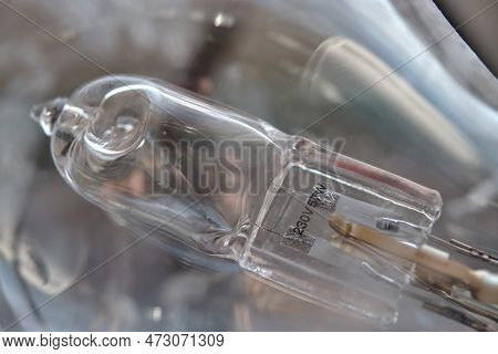 Close-up of a burned out malfunctioning incandescent light bulb with broken wolfram filament inside 