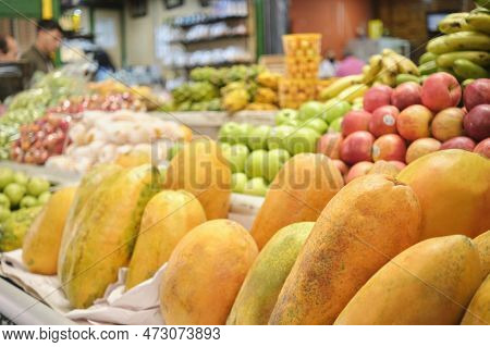 Papayas, Pawpaws, Or Papaws And Other Tropical Fruits For Sale At A Vegetable Market Stall.
