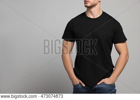 Man Wearing Black T-shirt On Light Grey Background, Closeup. Mockup For Design