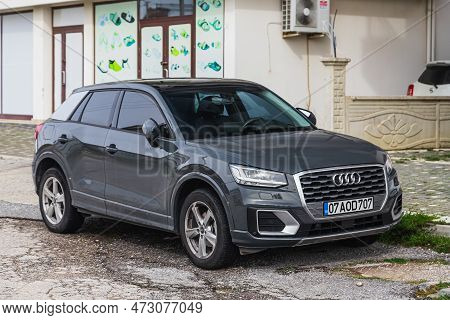 Side, Turkey - February 04 2023:     Gray Audi Q2  Is Parked  On The Street On A Warm  Day