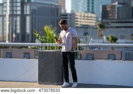 Young Handsome Man In Classik Polo T-shirt On The Street. Handsome Confident Stylish Hipster Model P