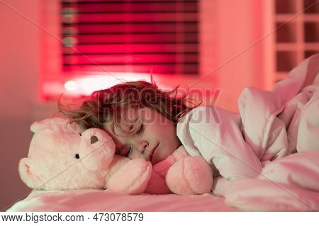 Sleep, Sleeping Concept. Child Sleeping In Bed With A Toy Teddy Bear. Cute Kid Sleeping Under Blanke