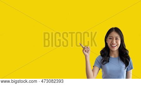 Asian woman pointing finger inviting click here, It is recommended to follow this direction or click