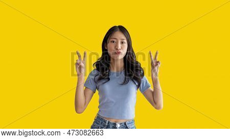 Young Asian Woman Making Two Thumbs Up Gesture Showing Joy And Fun, Symbol Of Good Friendship, Popul