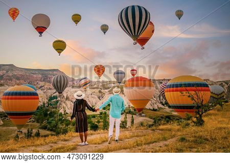 Cappadocia Turkey During Sunrise, Couple Mid Age Men And Woman On Vacation In The Hills Of Goreme Ca