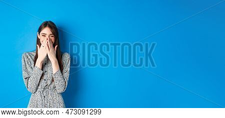 Cheerful Caucasina Girl In Dress Laughing And Having Fun, Covering Mouth With Hands And Chuckle Over