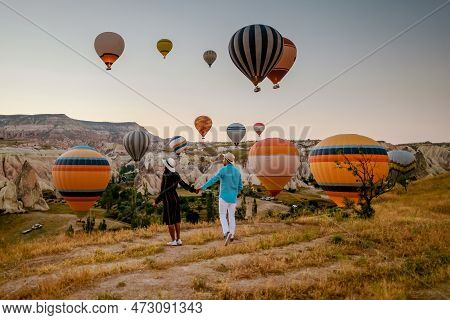 Cappadocia Turkey During Sunrise, Couple Mid Age Men And Woman On Vacation In The Hills Of Goreme Ca