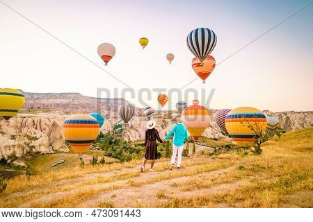 Cappadocia Turkey During Sunrise, Couple Mid Age Men And Woman On Vacation In The Hills Of Goreme Ca