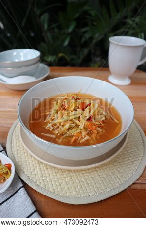 Sliced ​​fruit With Spicy Sauce On A White Bowl