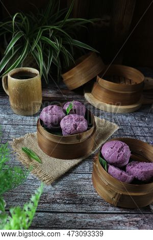 Indonesian Purple Steamed Cakes Served On A Bamboo Steamer