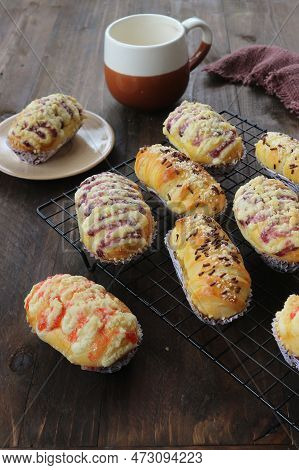 Sweet Bread With Jam And Chocolate And Cheese Sprinkles On A Wooden Background.