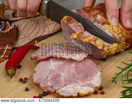 A Piece Of Juicy And Tasty Bacon Is Cut With A Kitchen Knife Into Appetizing Pieces. Close-up Of Fem
