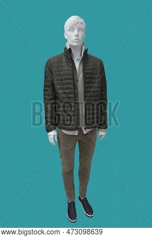 Full Length Image Of A Male Display Mannequin Dressed In Black Quilted Padded Jacket, Sweater And Co