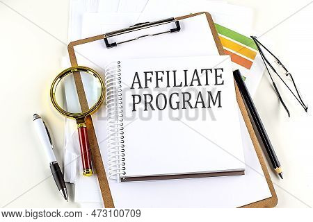 Affiliate Program Text On A Notebook With Clipboard On White Background