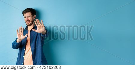 Guy Cringe From Something Disgusting Or Embarrasssing, Stretching Out Hands And Asking To Stop, Grim
