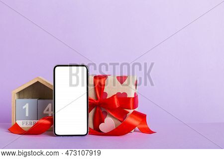 Mobile Phone With Blank Screen On Colored Background With Hearts, Calendar And Gift Box, Valentine D