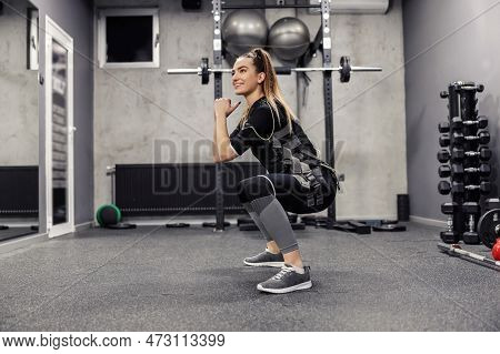 Training For An Adult Woman In An Electric Muscular Suit, Encourage Exercise At A Training Center. A