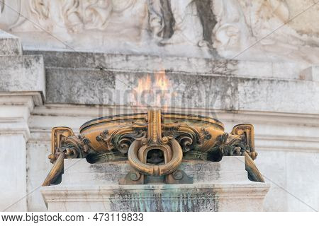 Rome, Italy - December 7, 2022: Flame At Tomb Of The Unknown Soldier, Under The Statue Of Goddess Ro