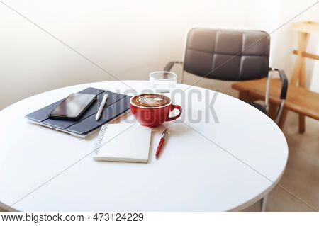 Desk Work Coffee Cup With Smart Phone Put On Tablet Computer, Notebook, Pen On White Table, Freelanc