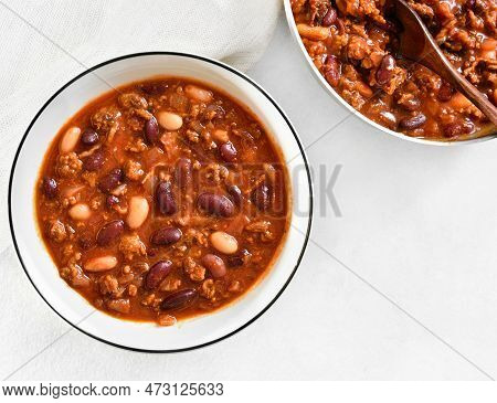 Stewed Beans With Ground Beef, Jalapeno Pepper And Bacon In Bowl Over White Stone Background. Top Vi