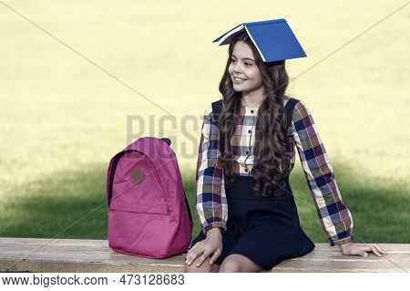 Fun Filled Learning. Funny Child Hold Book On Head. School Library. Reading Education. Knowledge And