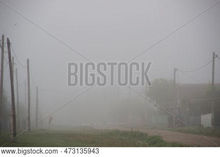 A Foggy Countryside Old Street With Retro Power Lines And Wood Telephone Poles, Green Grass, Minimal