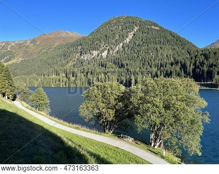 Sports And Recreational Trail Along The Alpine Lake Davos Or Loop Around Mountain Lake Davosersee, D