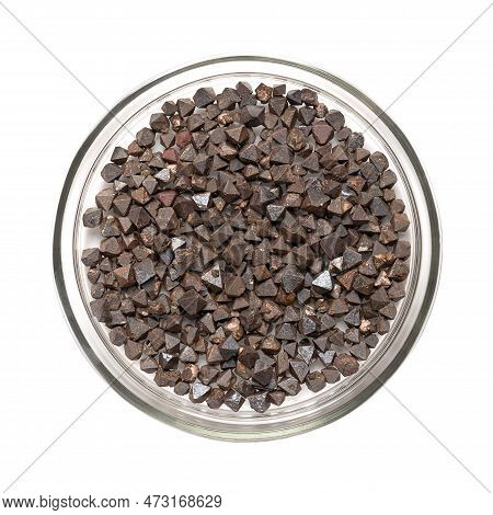 Magnetite Crystals In A Glass Dish. Iron(ii,iii) Oxide, Octahedral, Double Pyramid Shaped (a Platoni