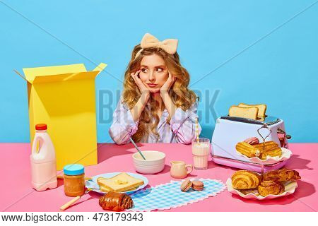 Image Of Upset Girl In Homewear And Bow Propping Up Cheeks And Looking Away From Food On Pink Tablec