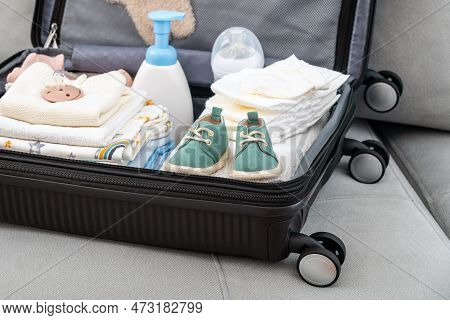 Bag For Maternity Hospital. Suitcase Of Baby Clothes Prepared For Newborn Birth. Concept Of Getting 