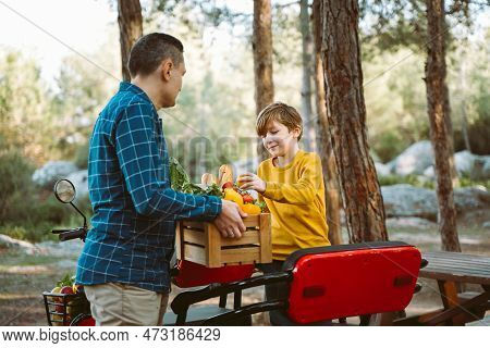 Farmer Father And School Boy Kid Delivered Wooden Crates With Vegetables To Camp Site For Picnic. Da