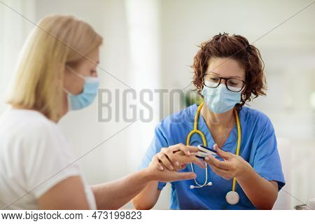 Doctor Examining Sick Patient. Ill Woman In Clinic