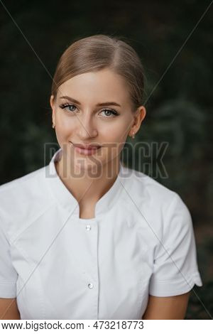 Smiling Confident Female Doctor With Lab Coat On Standing. Practician Woman