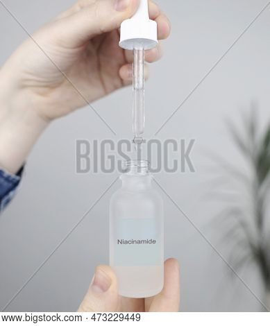 Niacinamide. Girl Applies Vitamin B3 To Her Face. Laboratory Research. Skincare. Dermatological Seru